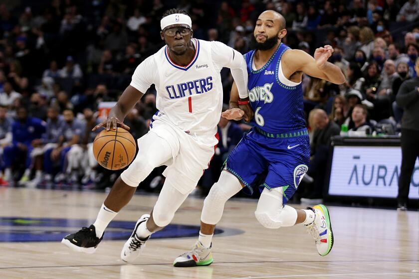 The Clippers' Reggie Jackson drives on the Timberwolves' Jordan McLaughlin during the first half Nov. 5, 2021.