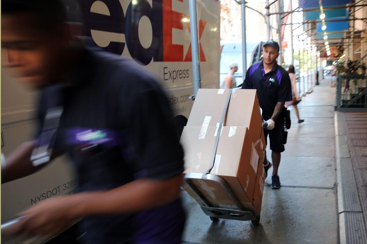 FedEx employees make deliveries in Manhattan.
