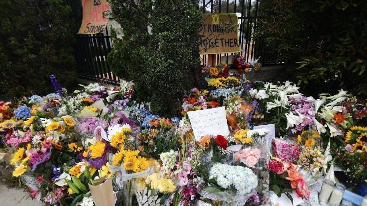 Flowers and candles are left outside the funeral for Lori Gilbert-Kaye, who was killed inside the Chabad of Poway synagogue.