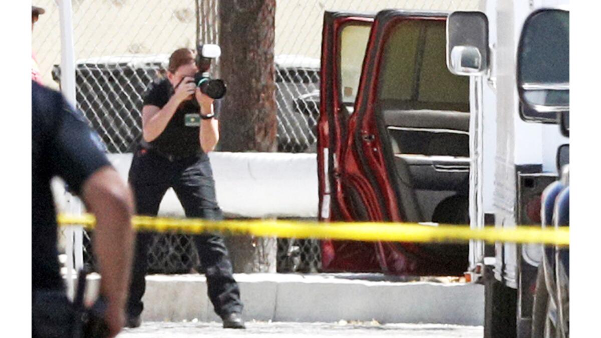 Law enforcement investigators examine the scene April 17 after three bodies were found in a vehicle on South Varney Street in Burbank.
