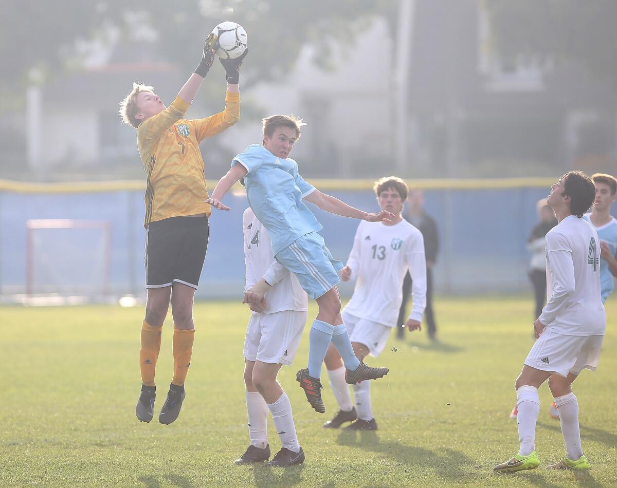 Edison goalkeeper Bennett Flory makes a save in a Surf League match at Corona del Mar on Jan. 11.