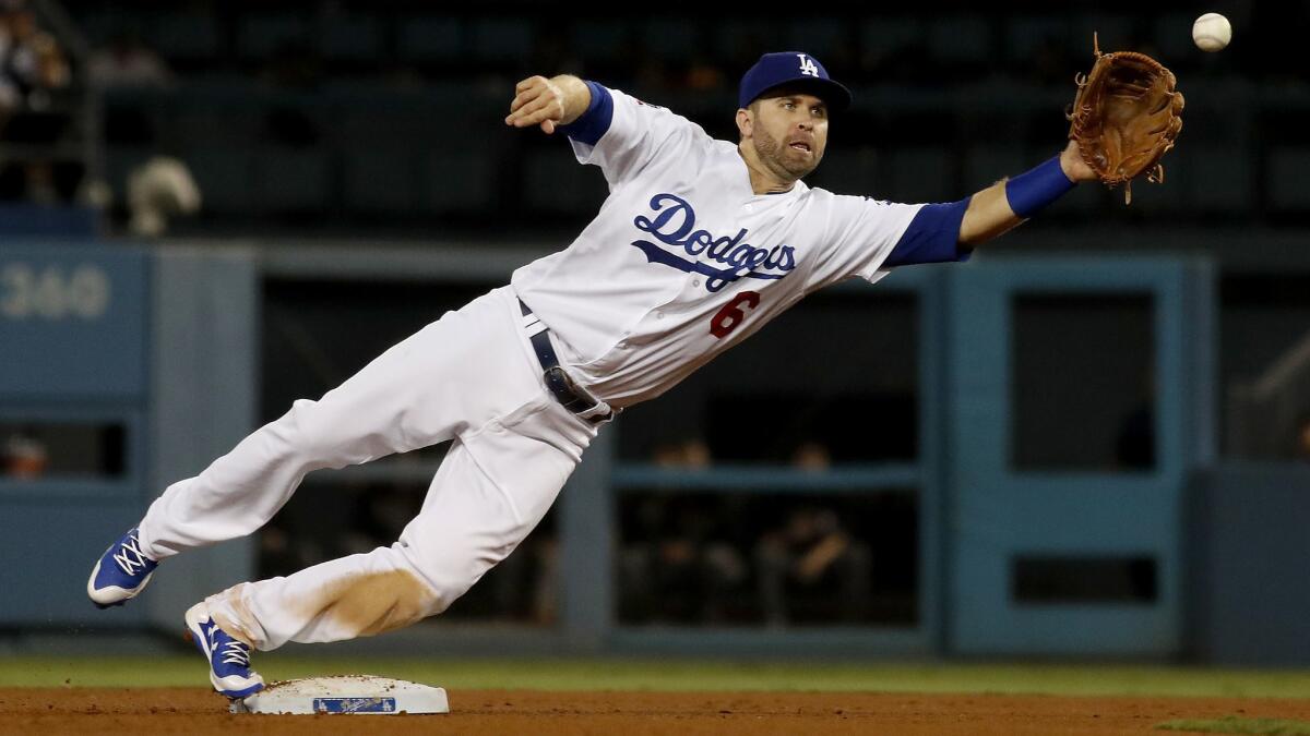 Dodgers second baseman Brian Dozier catches a wide throw on Aug. 30, 2018, at Dodger Stadium.