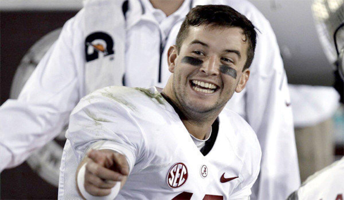 Quarterback A.J. McCarron is all smiles on the Alabama bench during a 48-7 Crimson Tide victory over Kentucky in which he passed for 359 yards and a touchdown with no interception.