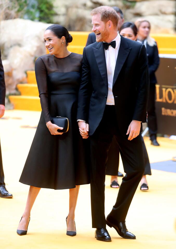 Prince Harry, Duke of Sussex and Meghan, Duchess of Sussex share a laugh at "The Lion King" European premiere at Leicester Square on July 14, 2019, in London, England.