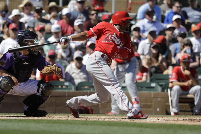 Los Angeles Angels' Ben Revere hits during a spring training baseball game against the Colorado Rockies, Thursday, March 16, 2017, in Scottsdale, Ariz. (AP Photo/Darron Cummings)