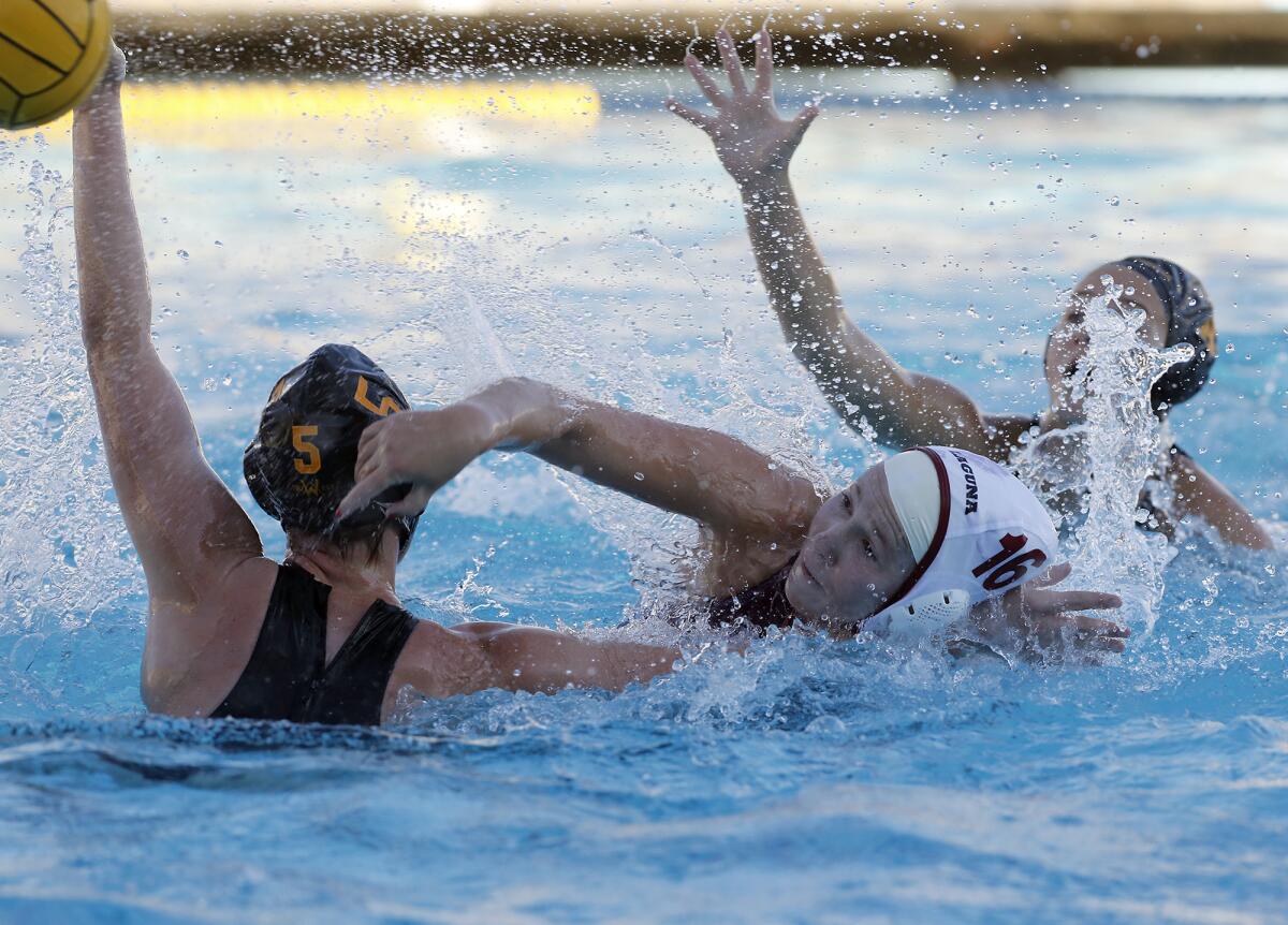 Laguna Beach's Nicole Struss (16) battles with Foothill's Claire Poissonnier (5) in the Irvine Southern California Championships title match at Irvine's Woollett Aquatics Center on Saturday.