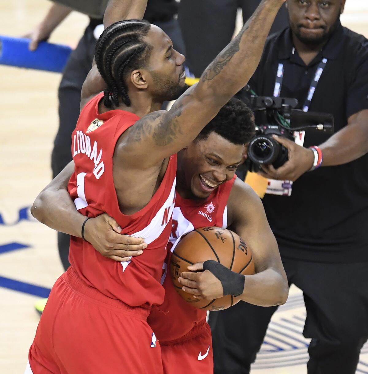 Toronto forward Kawhi Leonard, left, and guard Kyle Lowry celebrate after the final buzzer in the Raptors' championship-clinching win the Golden State Warriors in Game 6 of the NBA Finals at Oracle Arena in Oakland.
