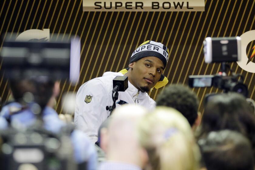 Panthers quarterback Cam Newton answers a question during the first day of media questioning prior to Super Bowl 50.