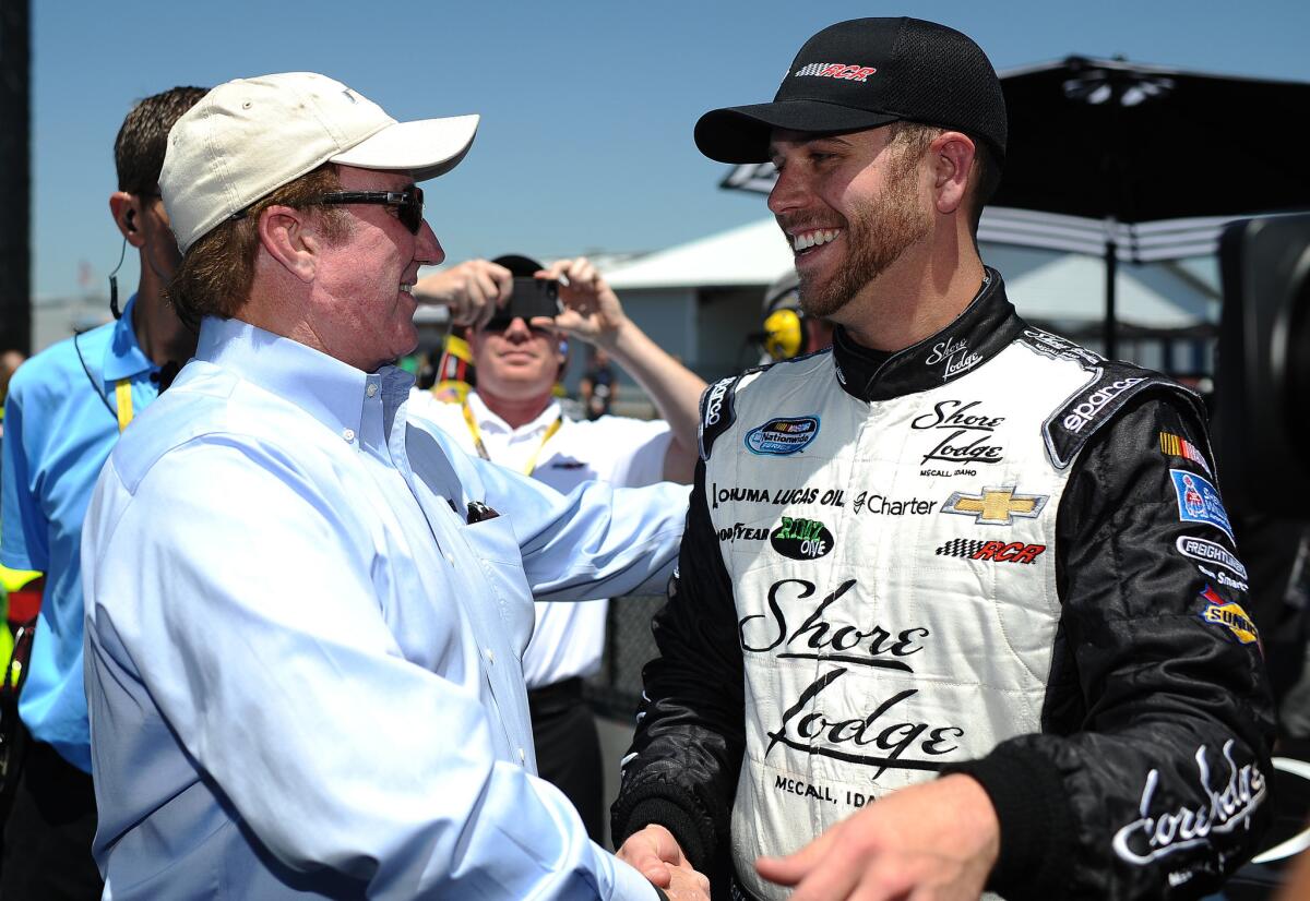 NASCAR driver Brian Scott is congratulated by team owner Richard Childress on Saturday after taking the pole for the Sprint Cup Series race at Talladega Superspeedway.