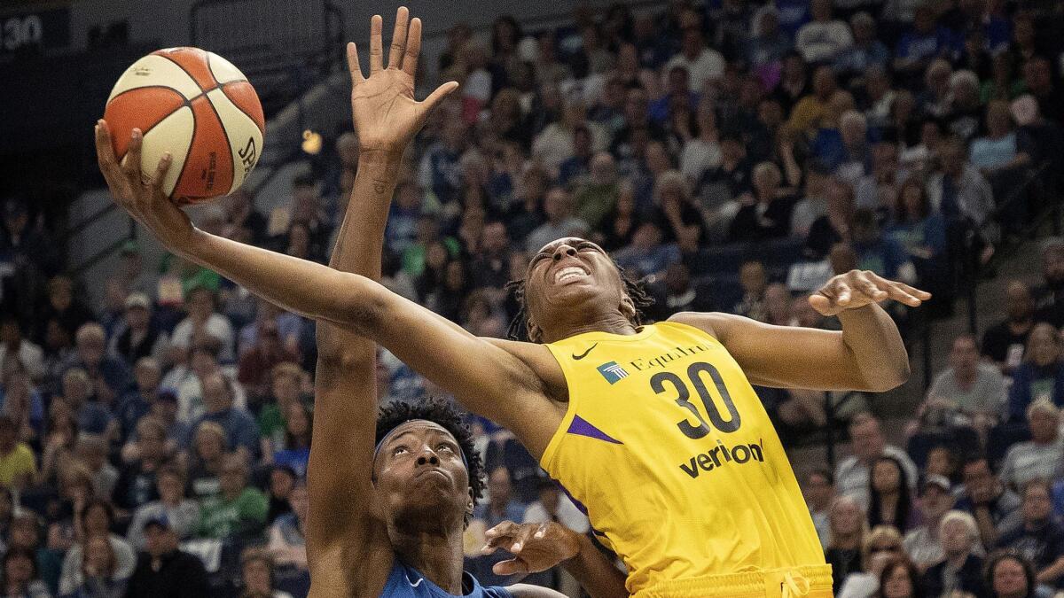 Sparks forward Nneka Ogwumike attempts a layup against Lynx center Sylvia Fowles during a WNBA game on May 20, 2018.