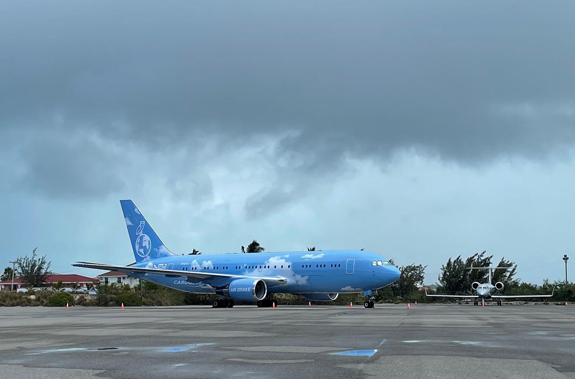 A Boeing 767 under a cloudy sky.