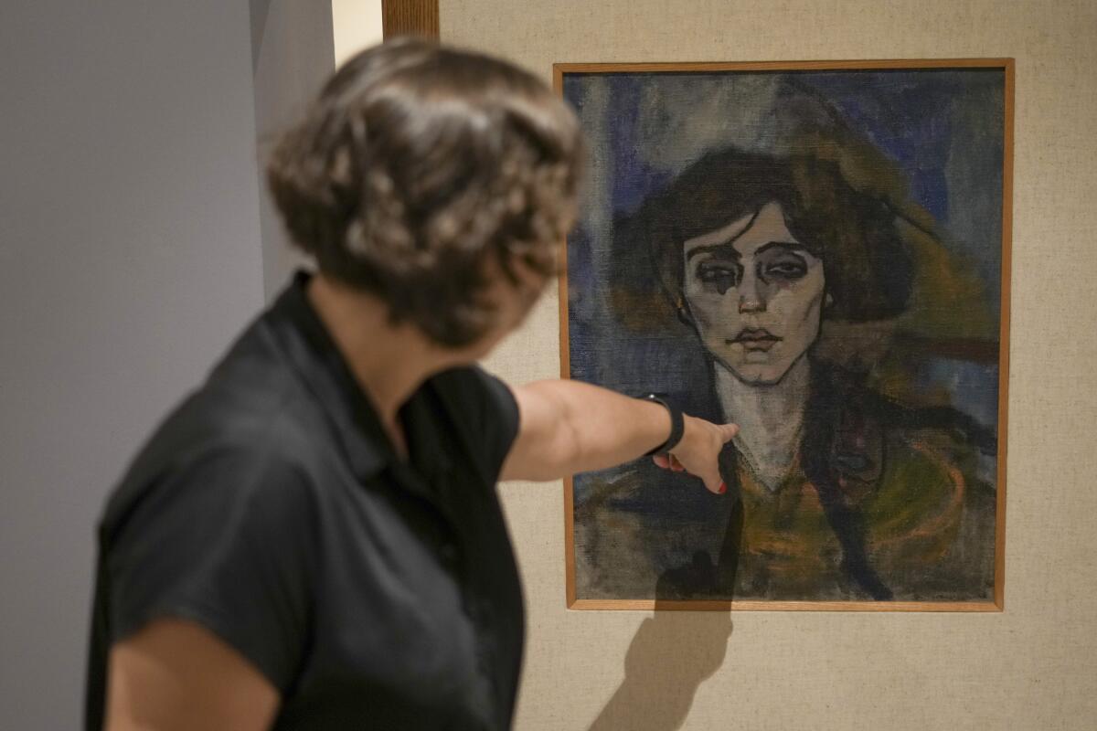 Woman pointing at Modigliani painting