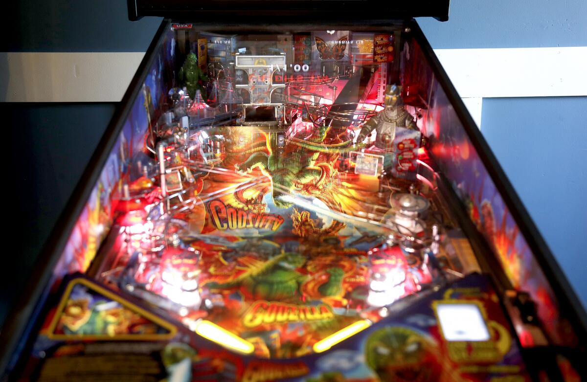 A modern pinball machine with a Godzilla theme.