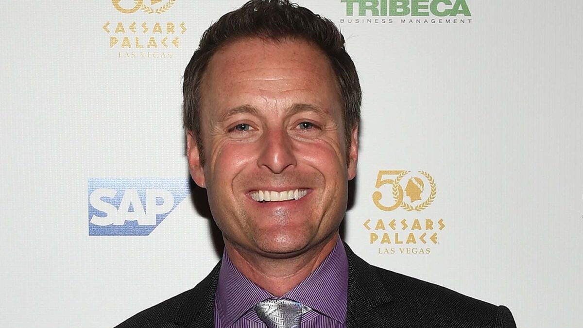Chris Harrison smiling in a suit