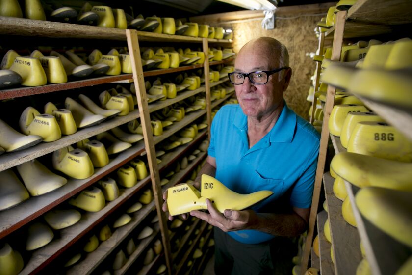 Randy Merrell poses for a portrait among shoe lasts at his workshop, Merrell FootLab, on Sunday, Sept. 22, 2019, just outside of Vernal, Utah. (Isaac Hale / For The Times)