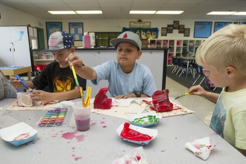 Students decorate art pieces during a YMCA of Orange County summer learning program at Peterson Elementary School in Huntington Beach in 2017.