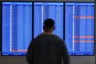 FILE - A traveler looks at a flight board with delays and cancellations at Ronald Reagan Washington National Airport in Arlington, Va., Wednesday, Jan. 11, 2023. Congressional investigators said in a report Friday, April 28, 2023, that an increase in flight cancellations as travel recovered from the pandemic was due mostly to factors that airlines controlled, including cancellations for maintenance issues or lack of a crew. (AP Photo/Patrick Semansky, File)