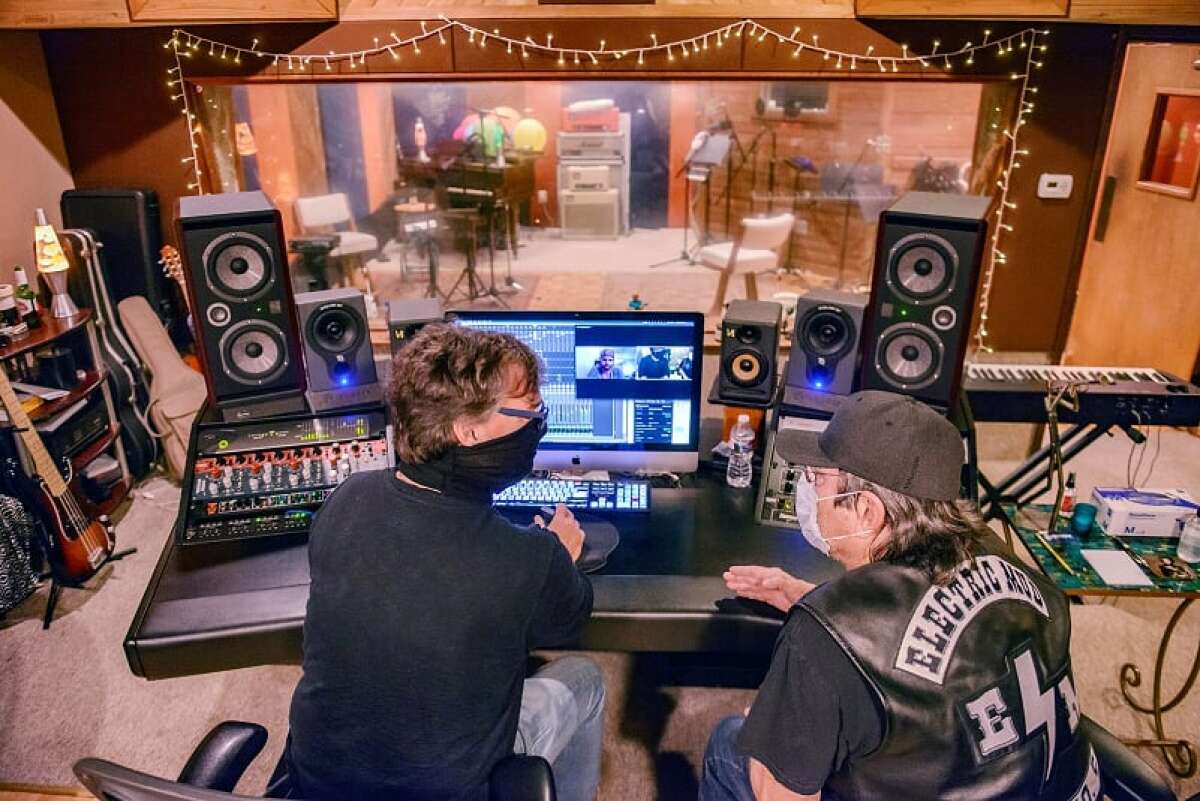 Alan Sanderson (left) and Electric Mud promoter Chris Faust put the finishing touches on the band's new album.