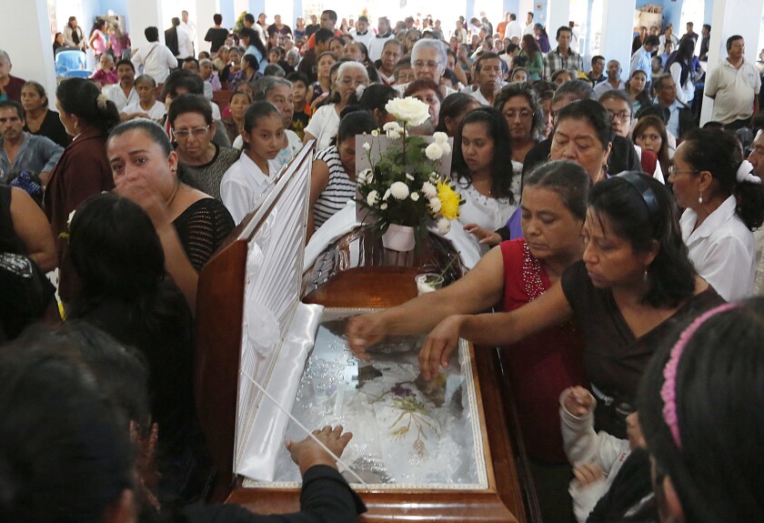 Mourners pay their last respects to the Rev. Jose Alfredo Suarez de la Cruz, who was gunned down in September in the Mexican state of Veracruz. This week, a judge who was out jogging was shot to death in Metepec.