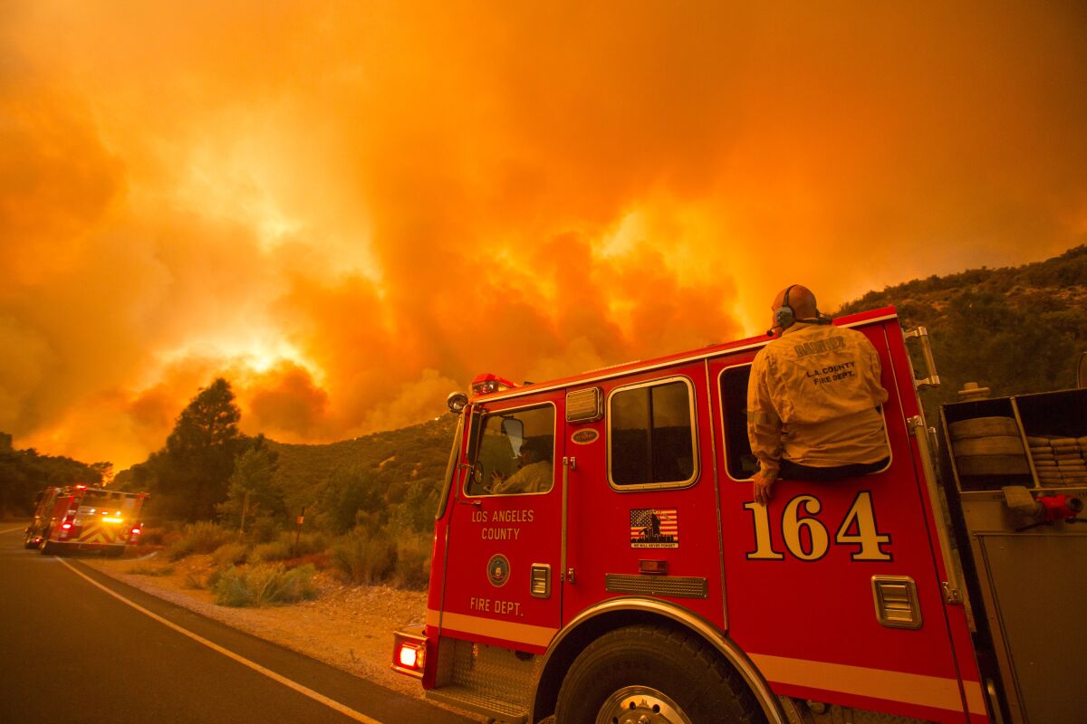Firefighters watch the Lake Hughes fire in the Angeles National Forest