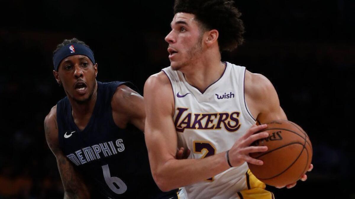 Lakers guard Lonzo Ball drives to the basket against Grizzlies guard Mario Chalmers in the first quarter of a game last season.
