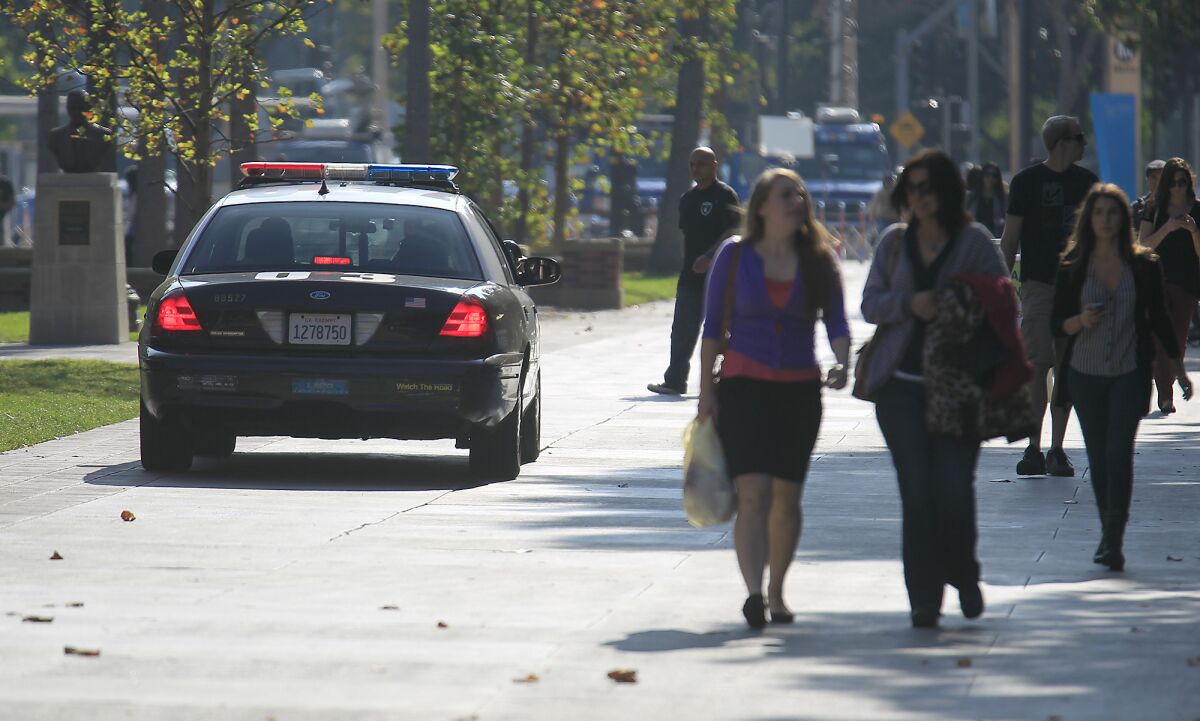 LAPD officers patrol on the USC campus a day after a shooting outside a Halloween party in 2012.