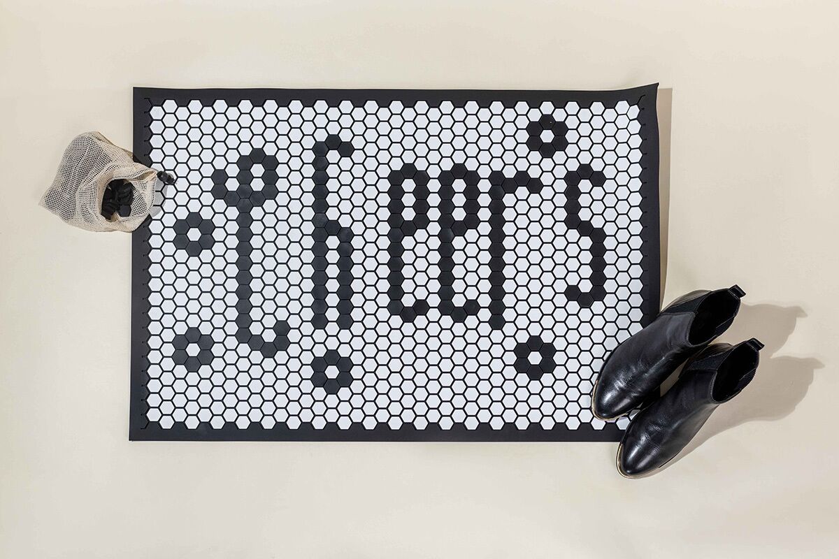 A doormat displaying the word "Cheers" by The Letterfolk Penny Tile Custom Doormat.
