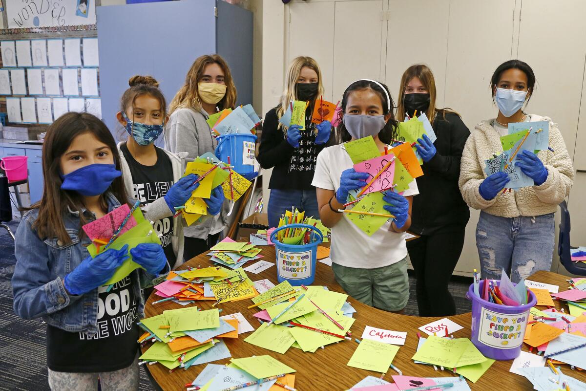 Students pose Friday with kindness grams intended to celebrate Kindness Week. 