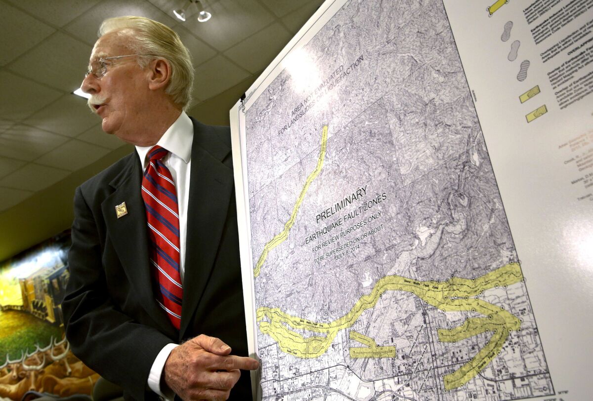 John Parrish, California's state geologist, points during at a news conference Wednesday to a new map showing the locations of faults in the foothills of eastern Los Angeles County.