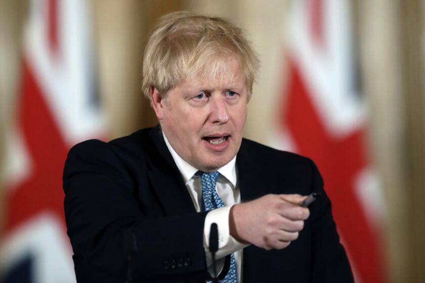 FILE - In this Tuesday, March 17, 2020 file photo, British Prime Minister Boris Johnson gestures as he gives a press conference about coronavirus inside 10 Downing Street in London. British Prime Minister Boris Johnson has been discharged from a London hospital where he was treated in intensive care for the new coronavirus. Johnson’s office says he left St. Thomas’ Hospital Sunday, April 12 and will continue his recovery at his country house Chequers. He will not immediately return to work. (AP Photo/Matt Dunham, file)