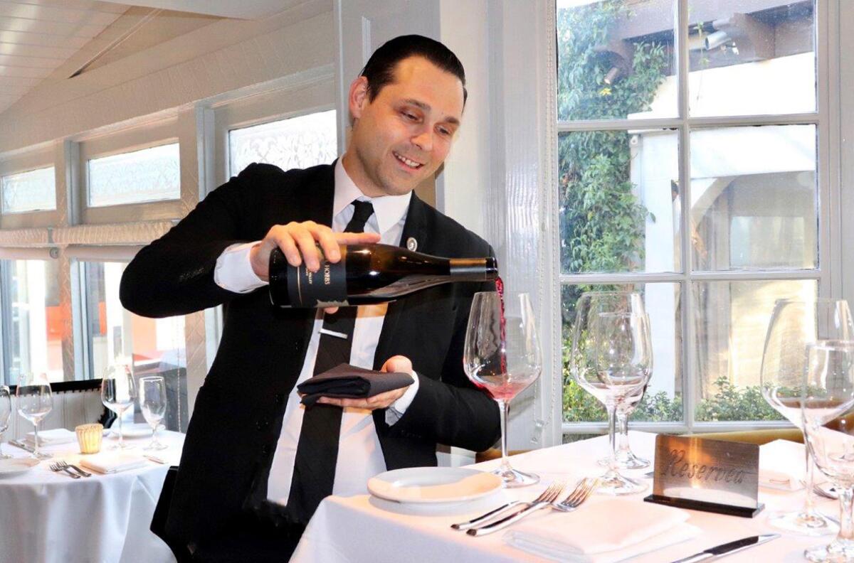 Certified advanced sommelier Vito Pasquale pours a glass at Selanne Steak Tavern in Laguna Beach.
