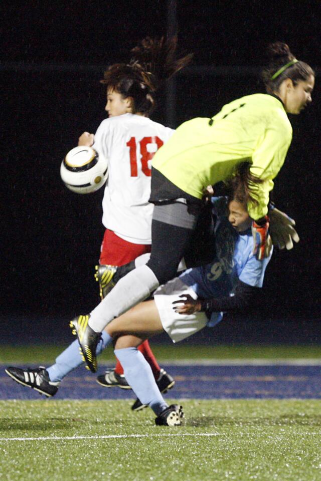 La Salle's keeper Sam Dier, top, tries to block the ball from CV's Lisa Kang during a game at La Salle High School in Pasadena on Friday, December 14, 2012.