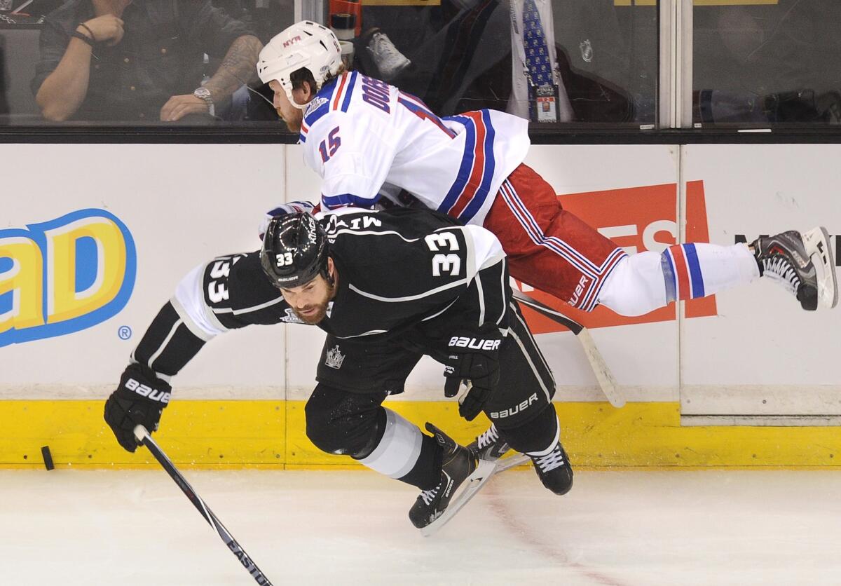 Kings defenseman Willie Mitchell collides with Rangers right wing Derek Dorsett in the first period of Game 2 on Saturday night at Staples Center.