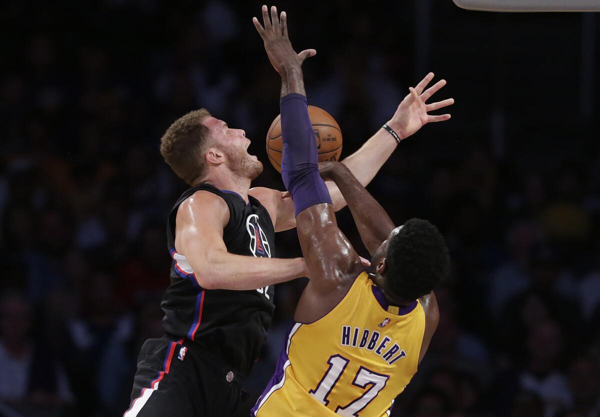 Clippers forward Blake Griffin is fouled by Lakers center Roy Hibbert during first half action.