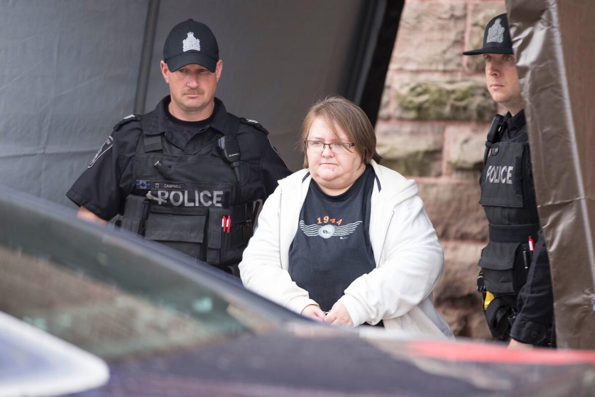Elizabeth Wettlaufer, a nurse accused in the murder of eight elderly patients in southern Ontario, leaves the courthouse in Woodstock, Ontario, Oct.