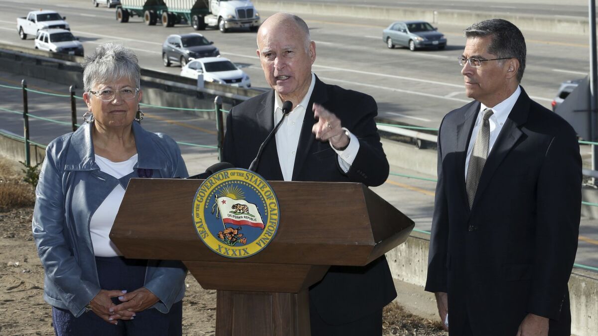 Calif., Governor Jerry Brown, center, blasts a Trump administration plan to freeze vehicle emissions standards at a press conference in Sacramento. Brown was joined by California Air Resources Board Chairwoman Mary Nichols, and Atty. Gen. Xavier Becerra.