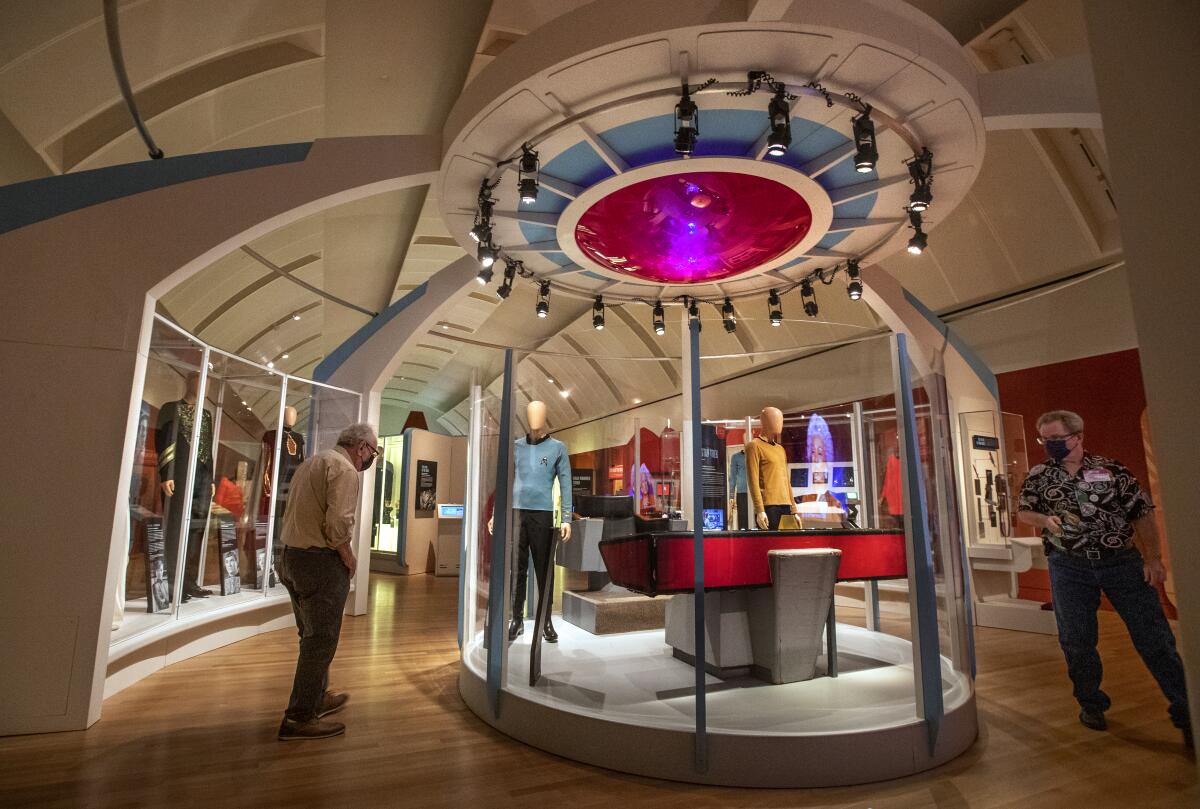 A glass vitrine holds costumes by the cast of the original "Star Trek."