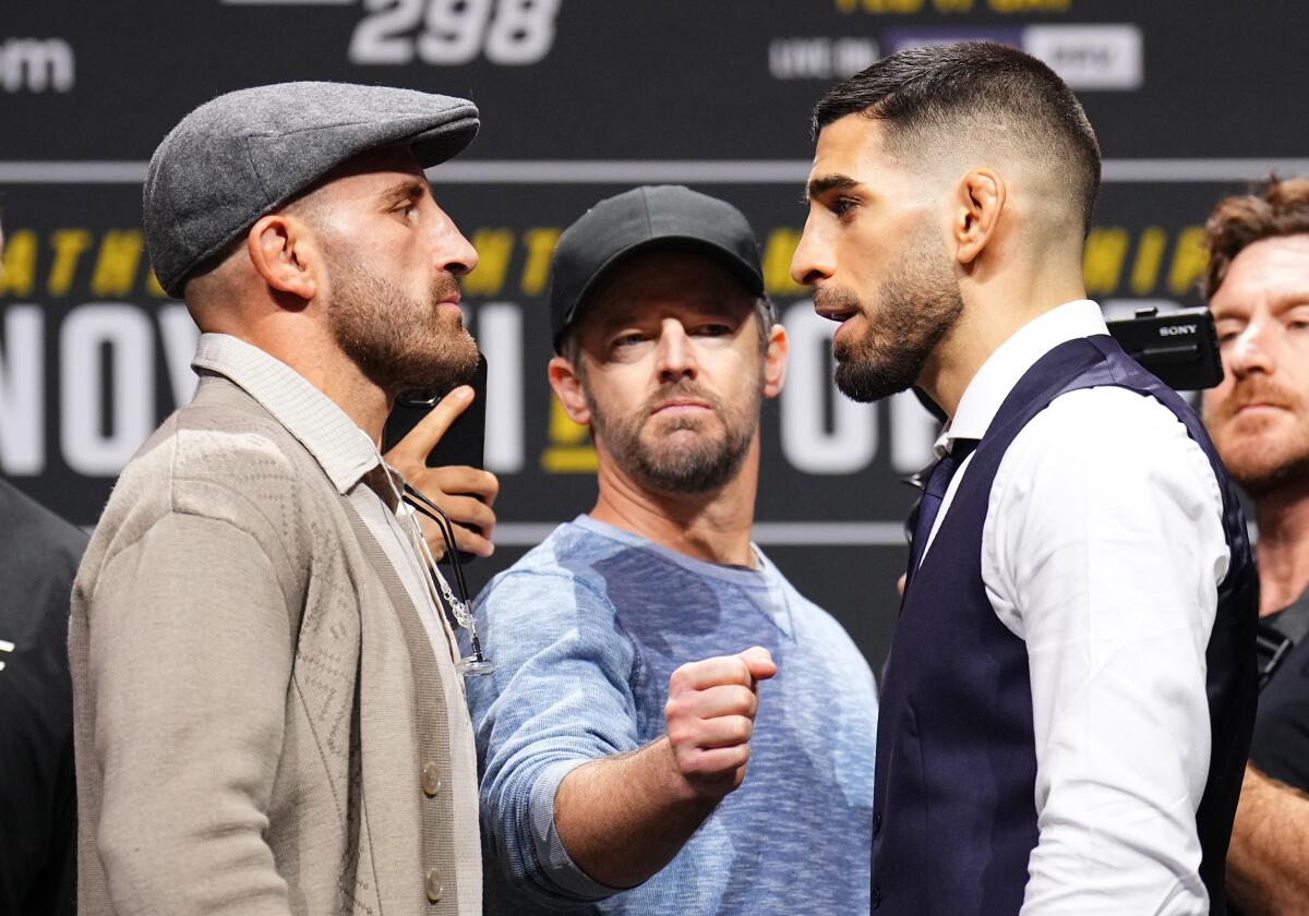 Alexander Volkanovski, left, and Ilia Topuria face off during a news conference at Honda Center on Thursday.