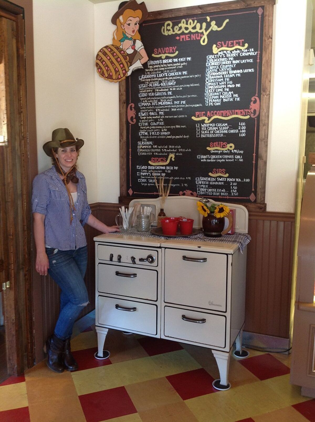 Elizabeth Harris with the menu board at Betty's Pie Whole in Encinitas. — Pam Kragen
