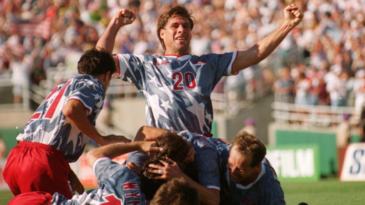 U.S. defender Paul Caligiuri, top, celebrates following a goal by teammate Earnie Stewart in a 2-1 win over Colombia at the Rose Bowl during the 1994 World Cup. The tournament served as a source of inspiration for many of the players who will be representing the United States at this year's World Cup in Rio de Janeiro.