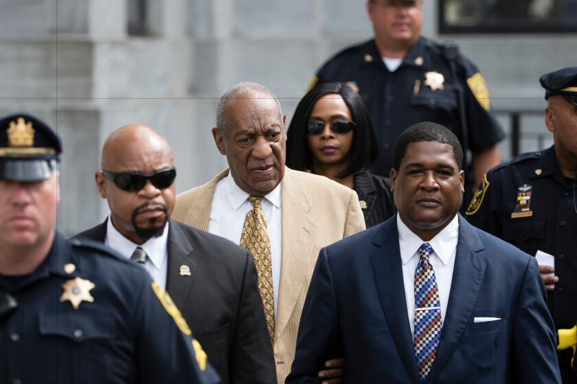 Bill Cosby, center, leaves a pretrial hearing at the Montgomery County Courthouse in Norristown, Pa., on Thursday.