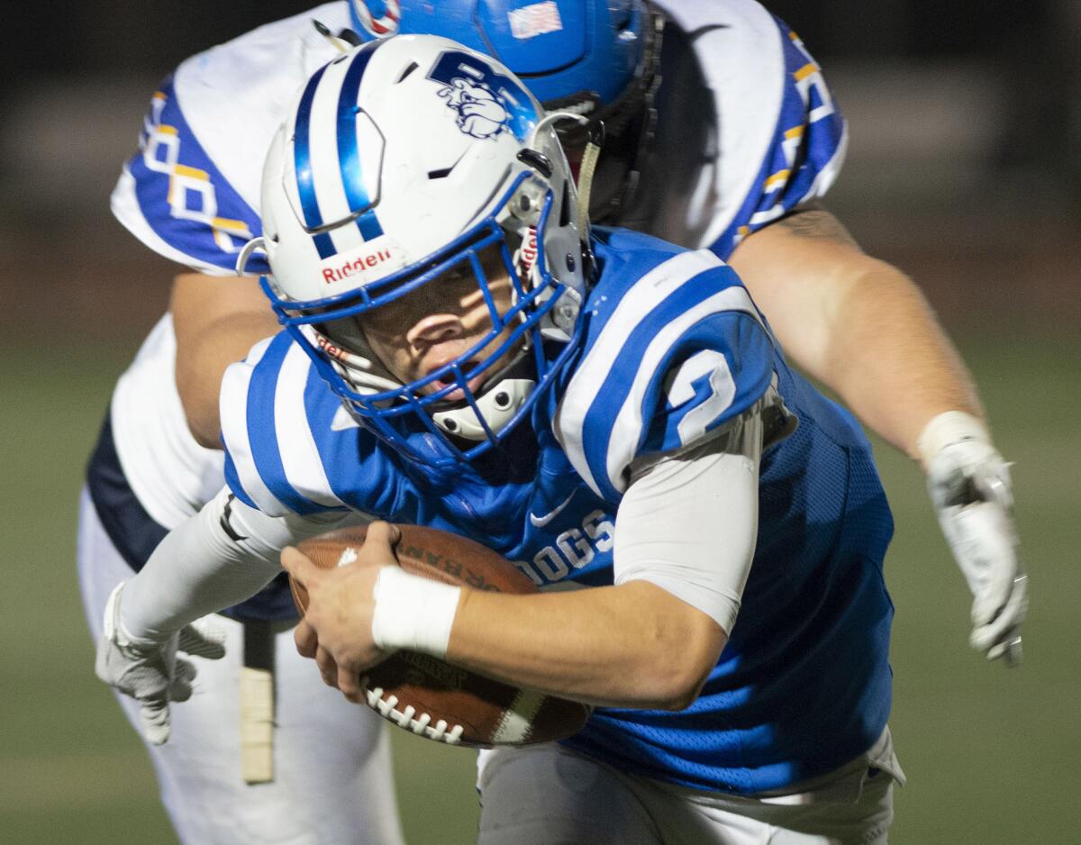 Burbank High's Vincent Vang tries to avoid being tackled by Serrano’s Cade Beaujean during Friday's CIF Southern Section Division VII quarterfinal playoff game at Memorial Field.