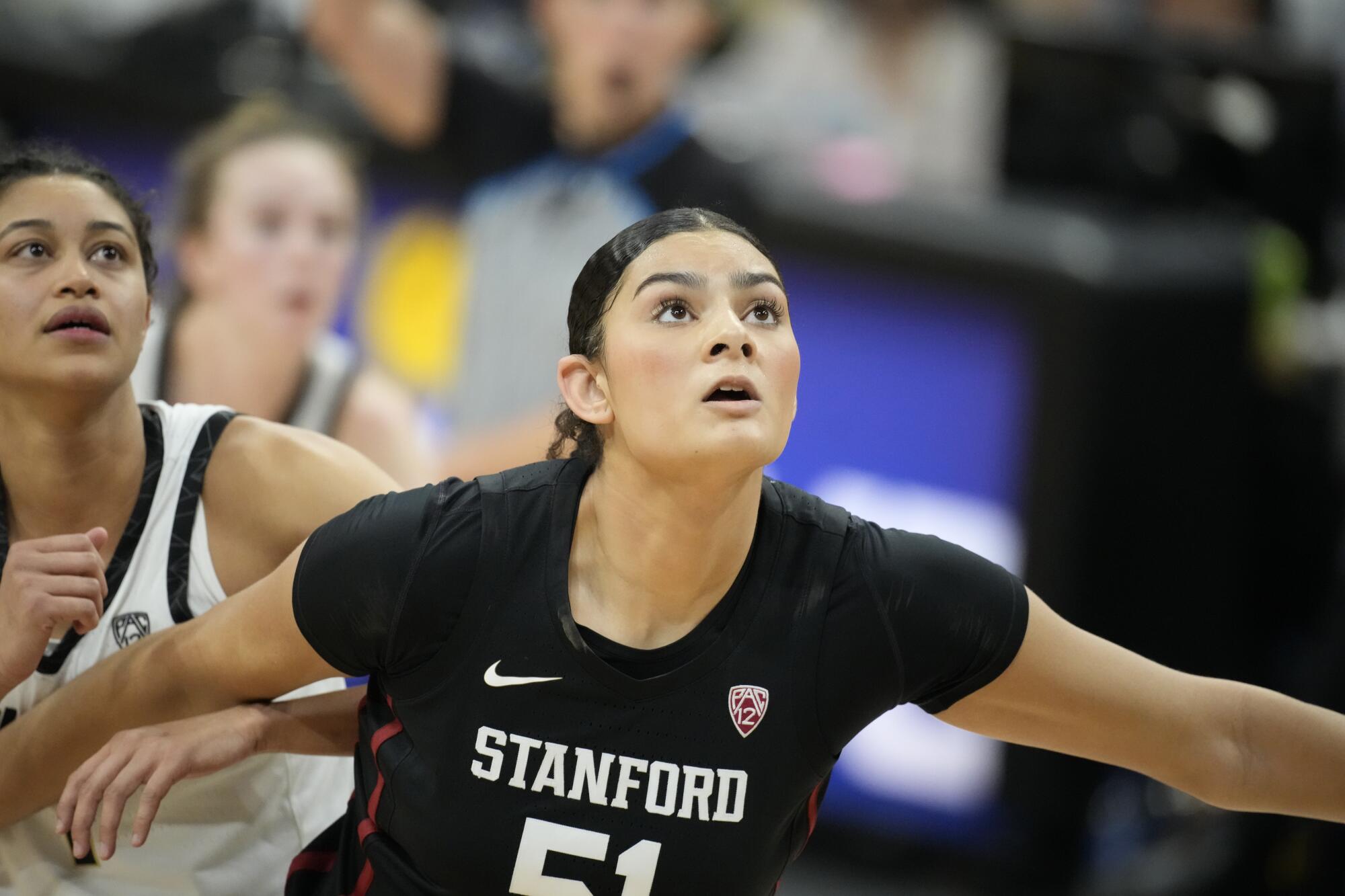 Stanford center Lauren Betts blocks out and looks up during a basketball game