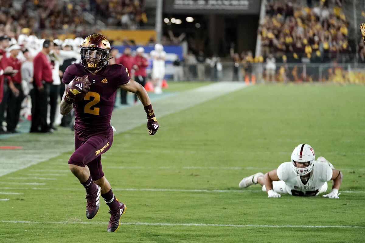 Arizona State defensive back DeAndre Pierce (2) returns a lateral after an interception for a touchdown, getting past Stanford tight end Bradley Archer, right, during the second half of an NCAA college football game Friday, Oct. 8, 2021, in Tempe, Ariz. Arizona State won 28-10. (AP Photo/Ross D. Franklin)