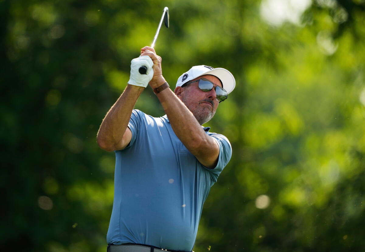 Phil Mickelson wears shades as he watches the ball after teeing off at the 2025 U.S. Open.