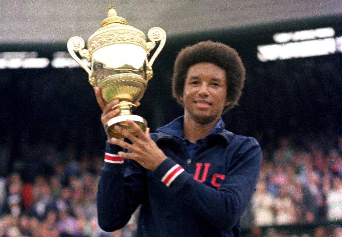 A man holds up a trophy.