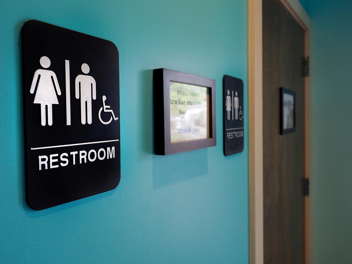 Unisex signs hang outside bathrooms at Toast restaurant on May 2016 in Durham, N.C.