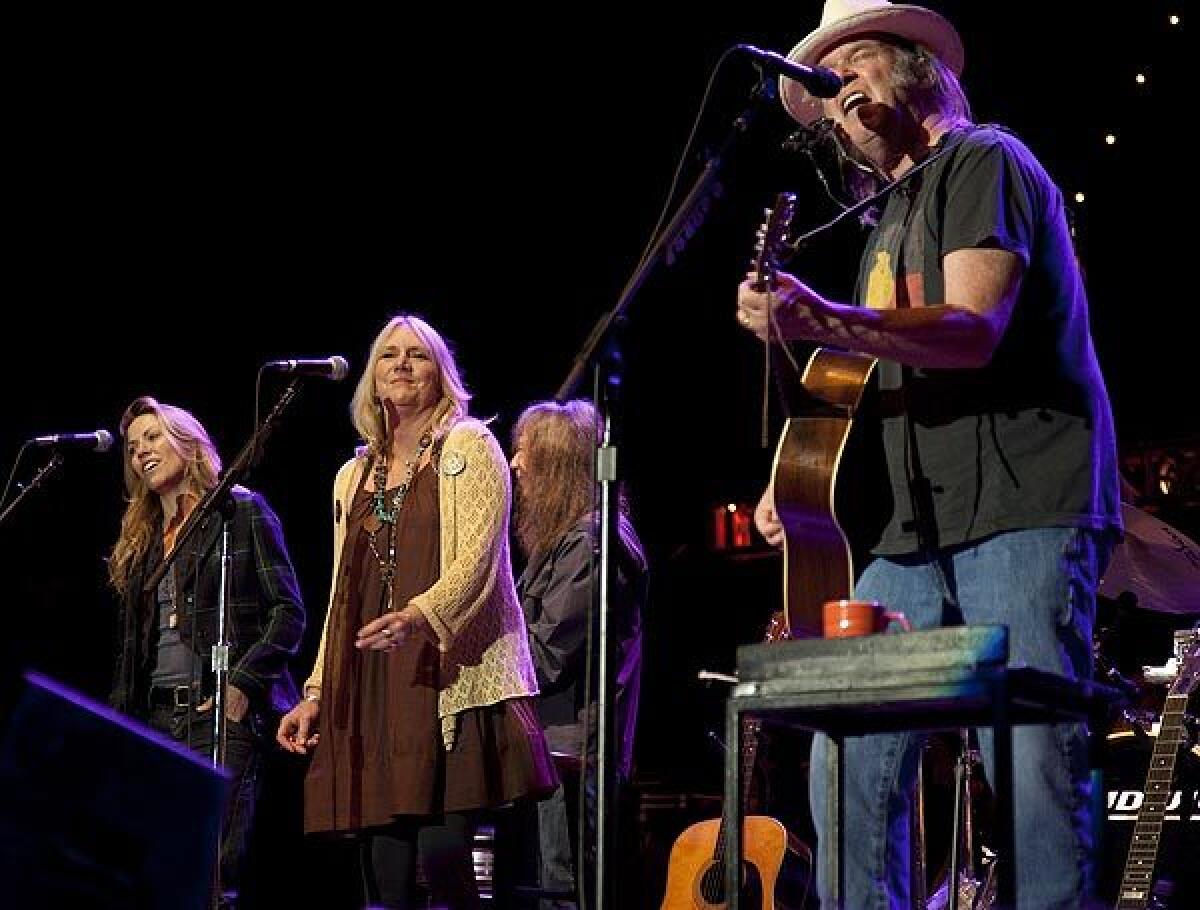 Sheryl Crow, from left, Pegi Young and Neil Young pefrom during the Bridge School Benefit Concert at Shoreline Amphitheatre in Mountain View, Calif., on Saturday.