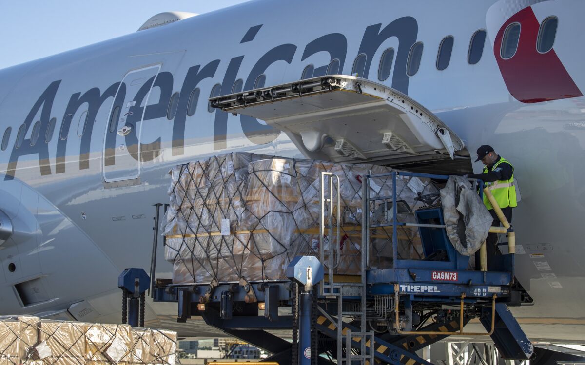 Cargo is unloaded from an American Airlines plane