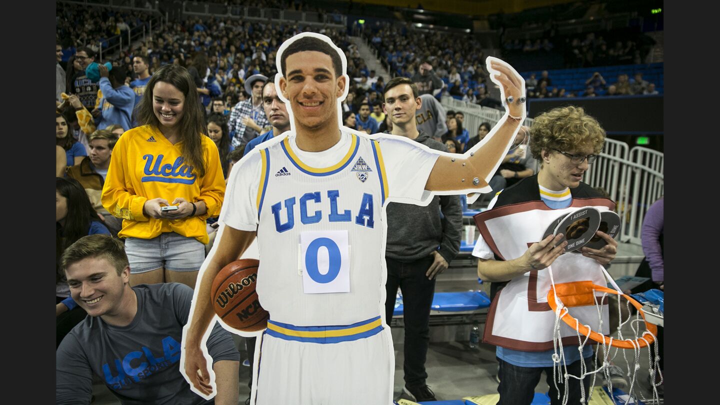 A Lonzo Ball cutout stands courtside at Pauley Pavilion before a game against Arizona State. Fans tally his score on his belly.